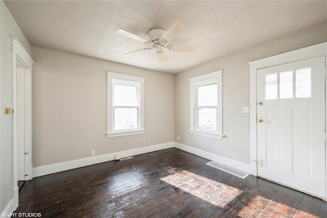 foyer entrance with ceiling fan and dark hardwood / wood-style floors