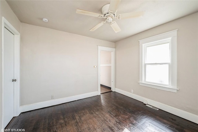 unfurnished bedroom featuring ceiling fan, dark hardwood / wood-style flooring, and a closet