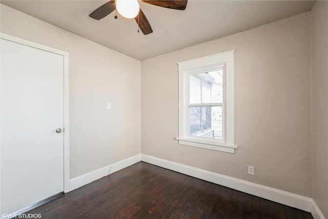 spare room with ceiling fan and dark hardwood / wood-style floors