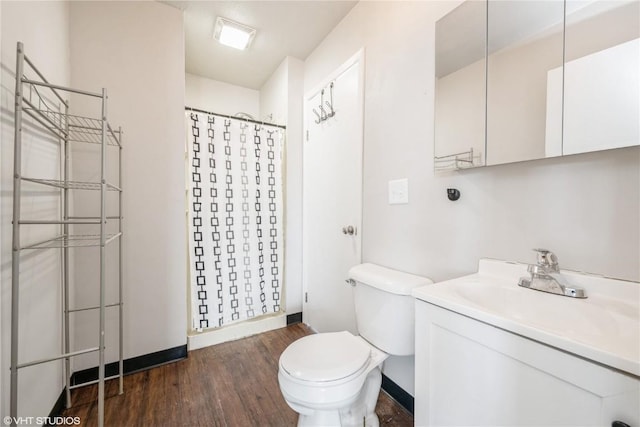 bathroom featuring toilet, vanity, a shower with shower curtain, and hardwood / wood-style flooring