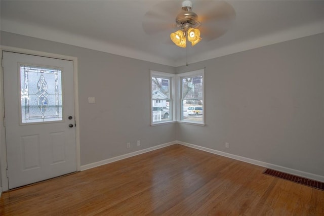 entryway featuring ceiling fan, a wealth of natural light, and hardwood / wood-style floors