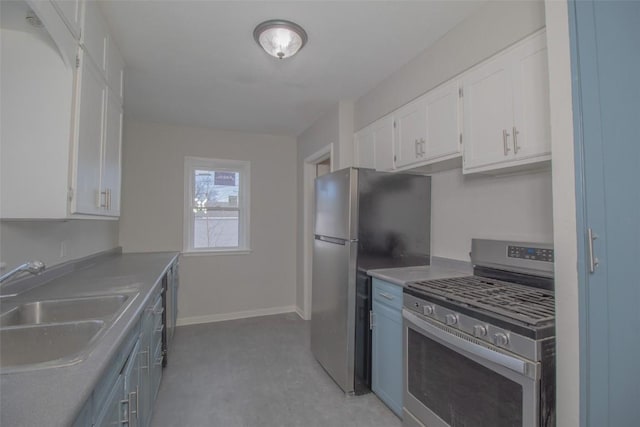 kitchen with stainless steel appliances, white cabinetry, and sink