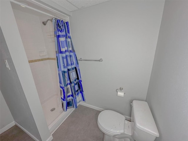 bathroom featuring walk in shower and toilet