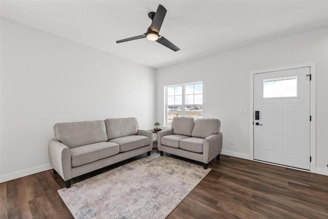 living room featuring ceiling fan and dark hardwood / wood-style floors