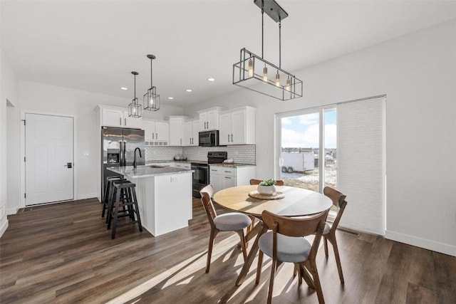 dining space featuring dark wood-type flooring