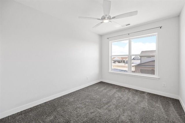 spare room featuring carpet and ceiling fan