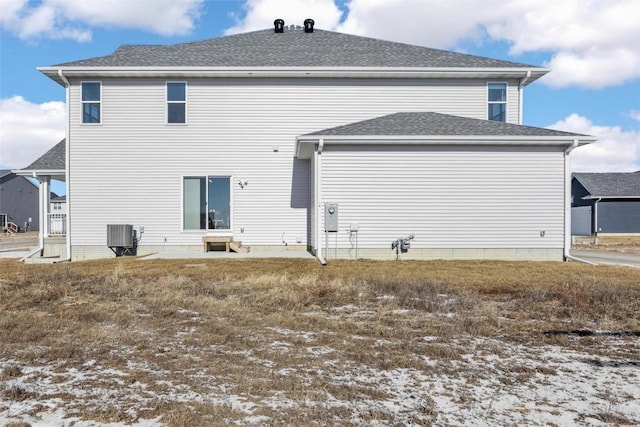 snow covered property with central AC unit