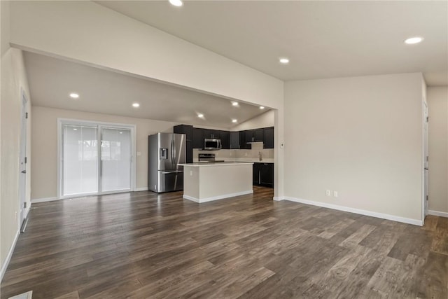 unfurnished living room with dark wood-type flooring and lofted ceiling