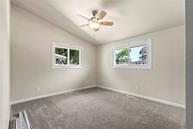 unfurnished room featuring ceiling fan, lofted ceiling, and carpet