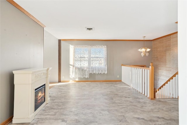 unfurnished living room featuring crown molding and a chandelier