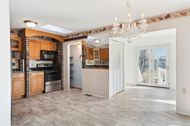 kitchen featuring electric range, a skylight, and an inviting chandelier