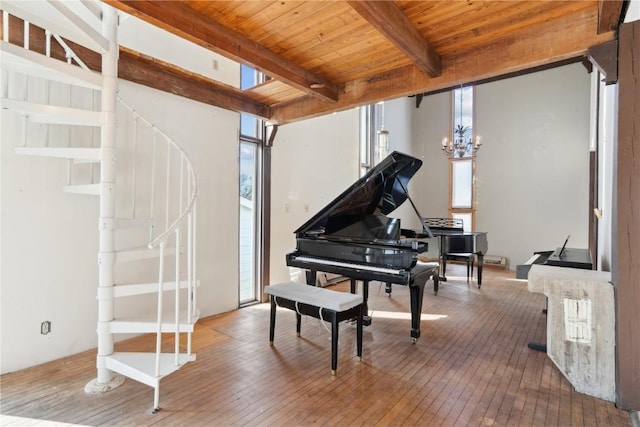 miscellaneous room with beam ceiling, wood ceiling, an inviting chandelier, and hardwood / wood-style flooring