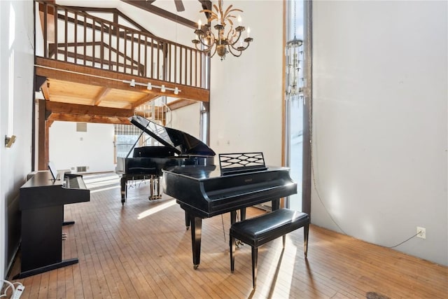 miscellaneous room with a chandelier and hardwood / wood-style flooring