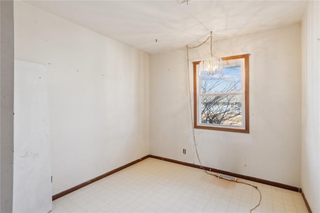 unfurnished room with a notable chandelier