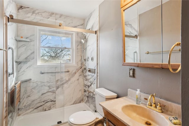 bathroom featuring walk in shower, vanity, and toilet