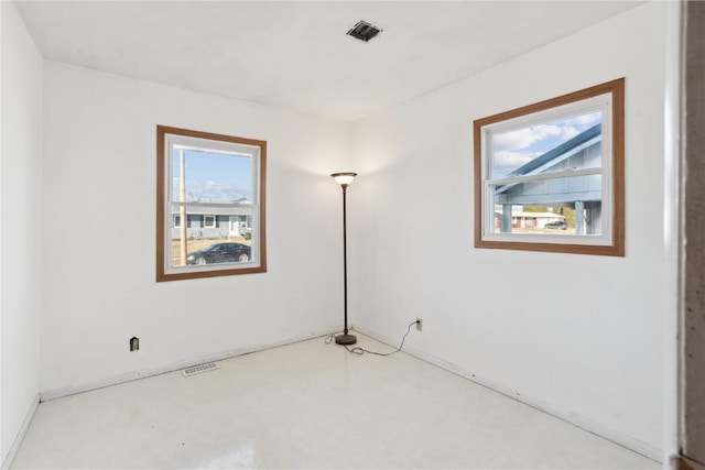 spare room with concrete floors and a healthy amount of sunlight