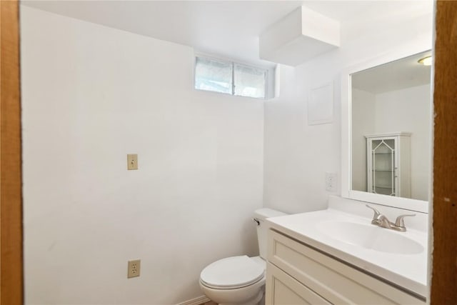 bathroom featuring toilet and vanity