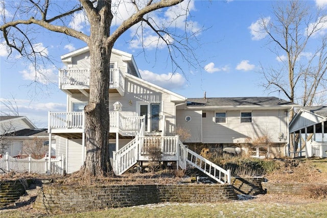 back of property with a balcony