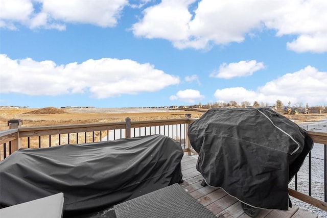 wooden terrace featuring a water view and area for grilling