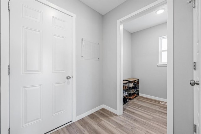 corridor with light wood-type flooring