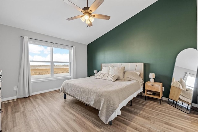 bedroom featuring ceiling fan, vaulted ceiling, and light wood-type flooring