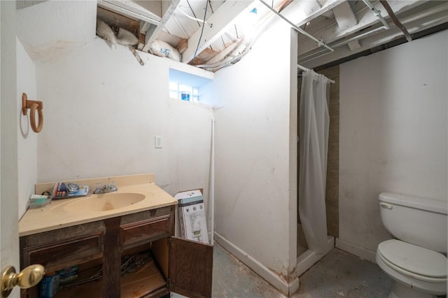 bathroom featuring toilet, vanity, and a shower with curtain