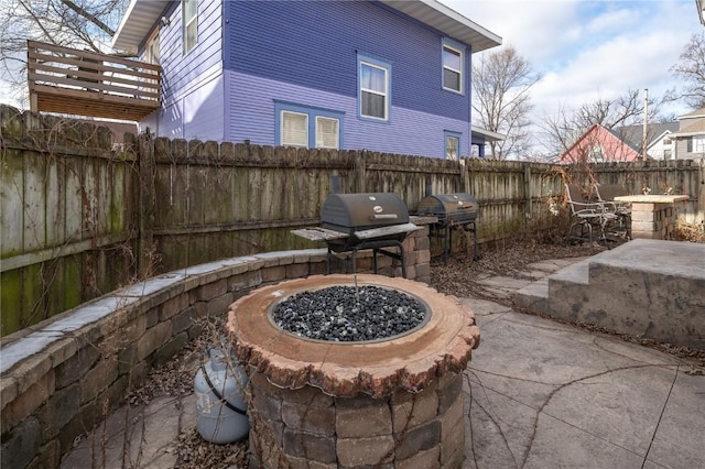 view of patio / terrace featuring area for grilling and a fire pit