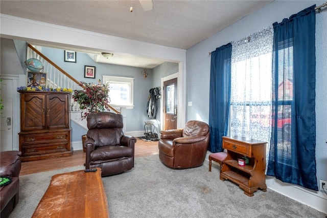 living room featuring carpet and a textured ceiling