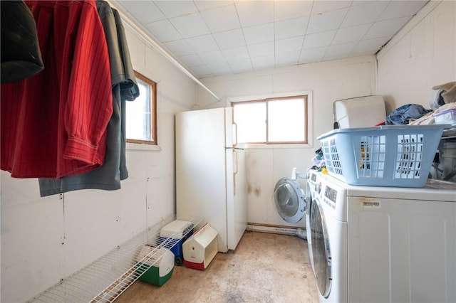 clothes washing area with washing machine and clothes dryer