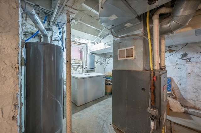 utility room featuring water heater