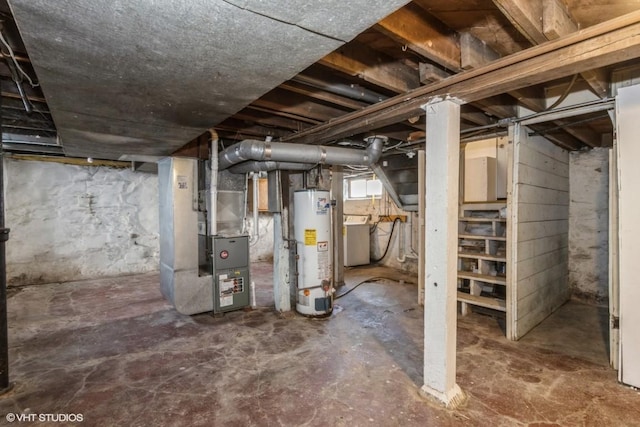 basement featuring heating unit, washer / clothes dryer, and gas water heater