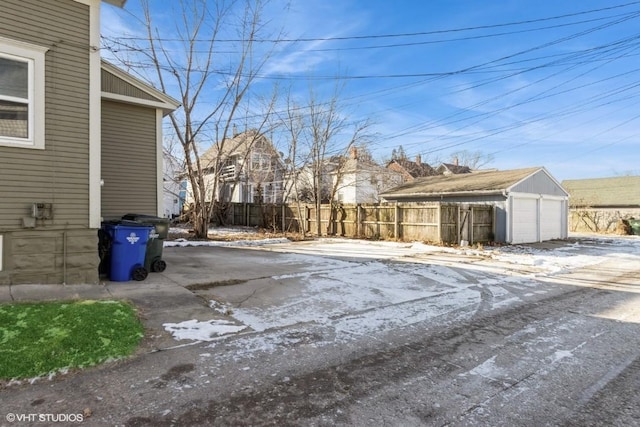 exterior space with a garage and an outdoor structure