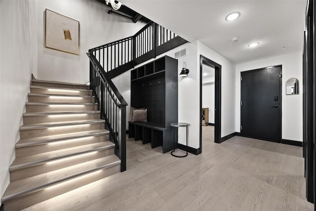 stairs featuring recessed lighting, wood finished floors, visible vents, and baseboards