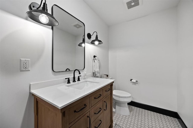 bathroom featuring toilet and vanity