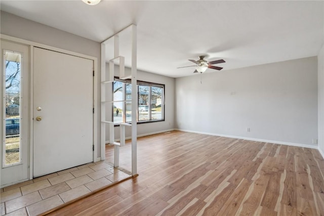 foyer entrance with ceiling fan and light hardwood / wood-style flooring