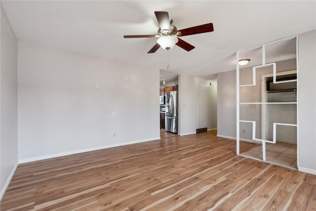 unfurnished living room with ceiling fan and light wood-type flooring