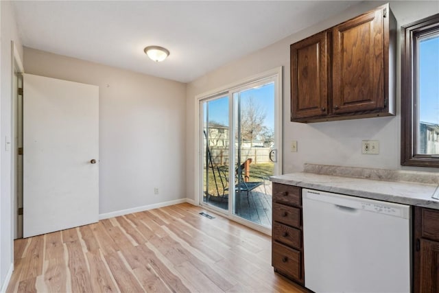 kitchen with white dishwasher, light hardwood / wood-style floors, and dark brown cabinetry