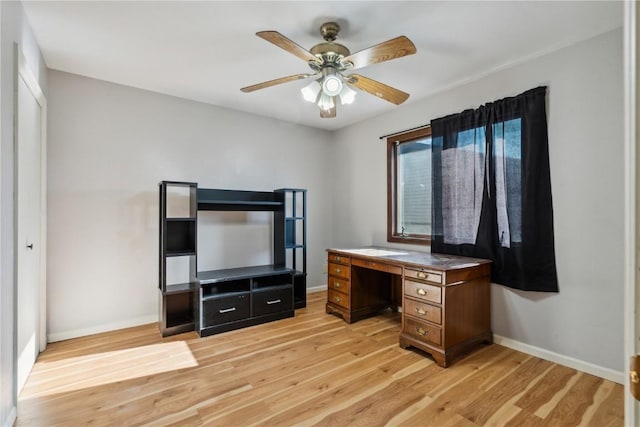 office with light hardwood / wood-style floors and ceiling fan