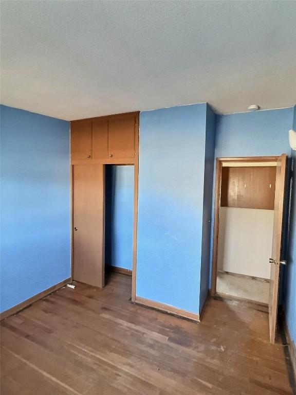 2270 26th St, Marion, IA 52302 - unfurnished bedroom featuring a closet and hardwood / wood-style flooring