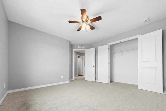 unfurnished bedroom with light carpet, ceiling fan, and a closet