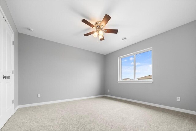 empty room featuring carpet floors and ceiling fan