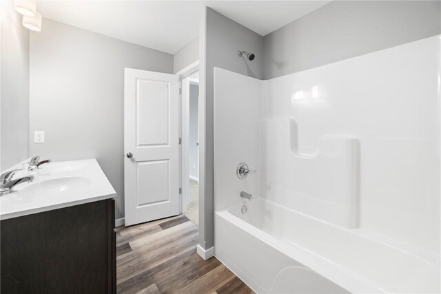 bathroom featuring hardwood / wood-style flooring, bathtub / shower combination, and vanity