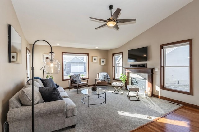 living room with vaulted ceiling, ceiling fan, and wood-type flooring