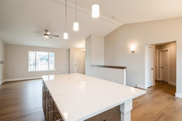 6188 Cope Dr, Marion, IA 52302 - kitchen featuring light wood-style flooring, vaulted ceiling, a ceiling fan, open floor plan, and a center island
