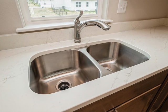 6188 Cope Dr, Marion, IA 52302 - kitchen view of a sink, dark brown cabinets, and light stone counters