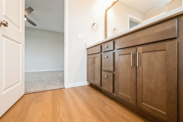 6188 Cope Dr, Marion, IA 52302 - bathroom with wood finished floors, vanity, a ceiling fan, and baseboards