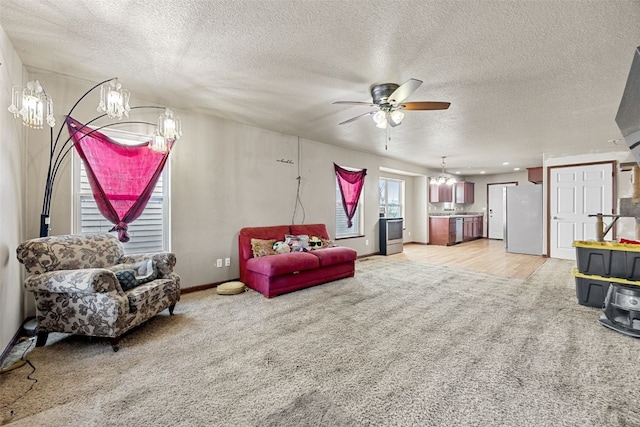 carpeted living room featuring a textured ceiling and ceiling fan