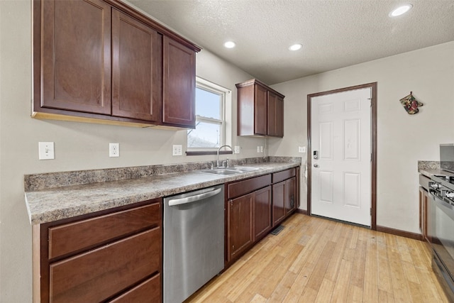 kitchen featuring sink, stainless steel dishwasher, light hardwood / wood-style floors, a textured ceiling, and black gas range