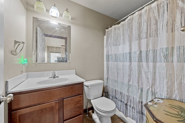 bathroom with tile patterned flooring, vanity, a shower with shower curtain, and toilet