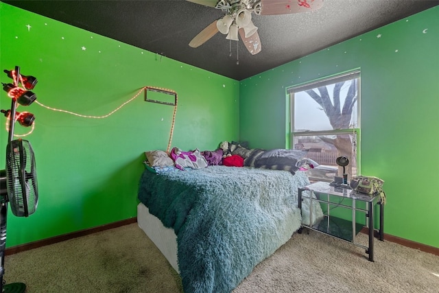 carpeted bedroom featuring ceiling fan and a textured ceiling